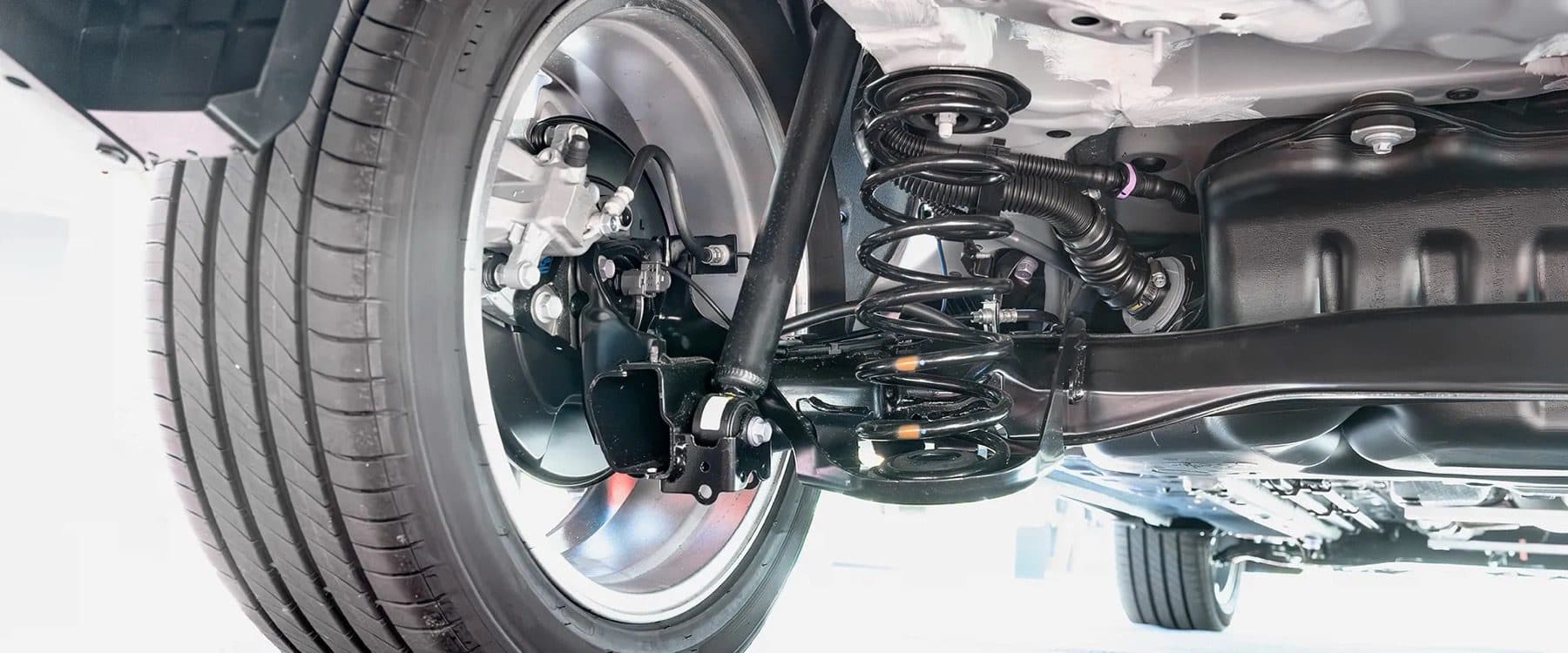 Underside view of a truck's suspension and wheel during service at Chapman's Automotive in Craig, Colorado